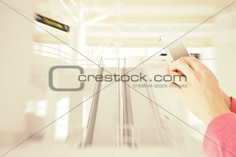 Composite image of woman texting with her mobile phone