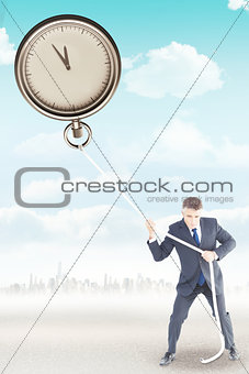 Composite image of businessman in suit pulling a rope