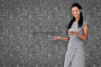 Composite image of businesswoman using smartphone
