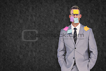 Composite image of businessman with post its on face
