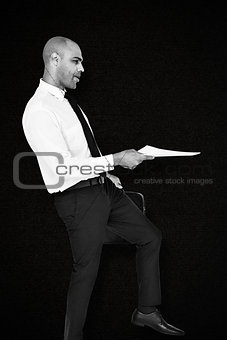 Composite image of businessman with document