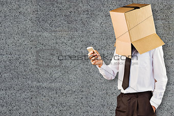 Composite image of anonymous businessman with his smartphone