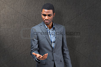 Composite image of focused businessman holding hand out