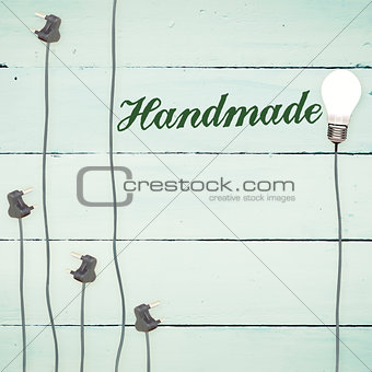 Handmade against light bulbs on wooden background