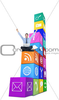 Composite image of smiling businessman sitting on the floor cheering