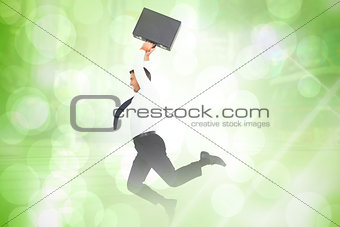 Composite image of smiling businessman leaping while briefcase
