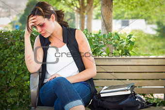 Depressed Bruised and Battered Young Woman on Bench