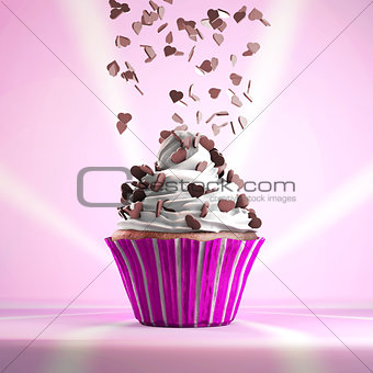 Delicious cupcake with chocolate hearts sprinkled on a whipped cream.