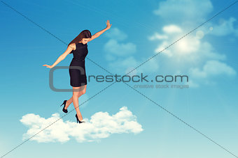 Businesswoman standing on cloud