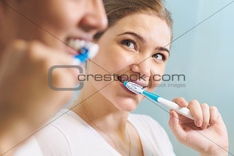 Couple Washing Teeth Man And Woman Together In Bathroom
