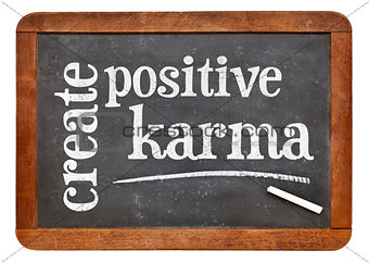 create positive karma - text on blackboard