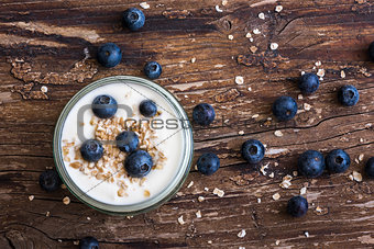 Yogurt with Fresh Blueberries on Woden Table