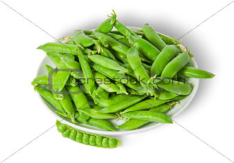 Opening and closing pea pods on white plate top view