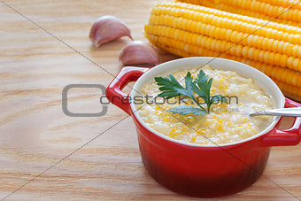 Brazilian corn soup canjiquinha in red bowl