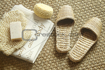Spa setting with slippers, towel and soap