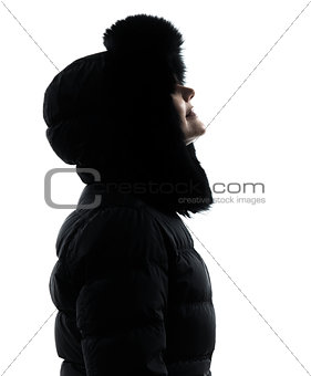 woman winter coat looking up smiling silhouette