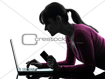 woman holding credit card computing laptop computer silhouette