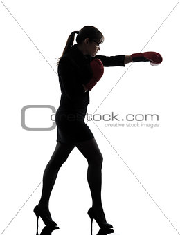business woman punching boxing gloves silhouette