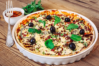 Pizza homemade with sauce on wooden background