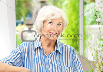 Senior woman sitting at home