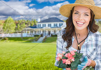 Young Woman Gardening in Front of Beautiful House