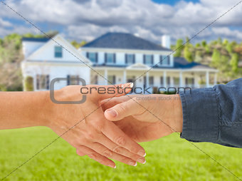 Man and Woman Shaking Hands in Front of New House