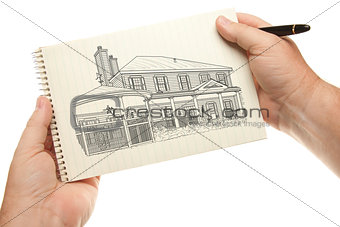 Hands Holding Pen and Pad of Paper with House Drawing
