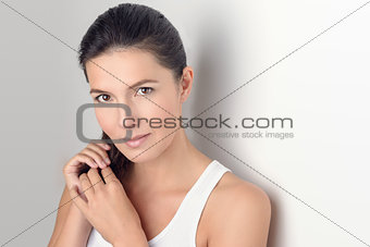 Woman Smiling at the Camera While Holding her Hair