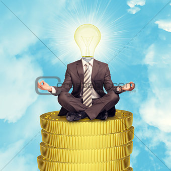 Sitting businessman on coins step
