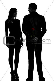 one couple man hiding rose flower and woman smiling silhouette