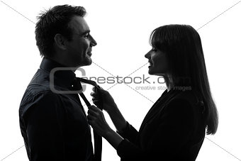 couple woman helping man tying silhouette