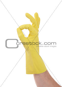 Hand gesturing with yellow cleaning product glove