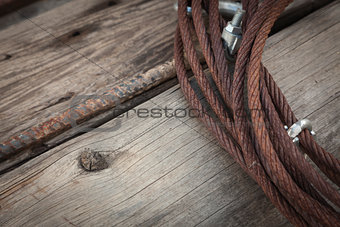 Abstract Rusty Iron Cable Laying on Old Wood Planks