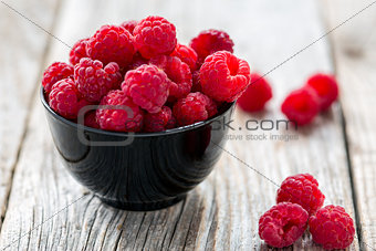 Bowl with ripe raspberry.