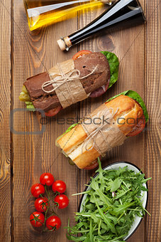 Two sandwiches, salad and spices
