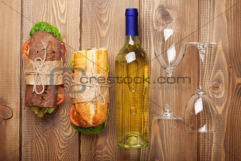 Two sandwiches and white wine