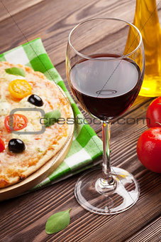 Glass of red wine and italian pizza