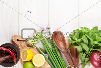 Fresh herbs and spices on wooden table