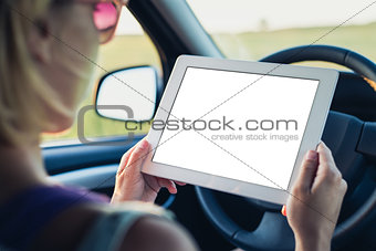 Woman using tablet pc in the car