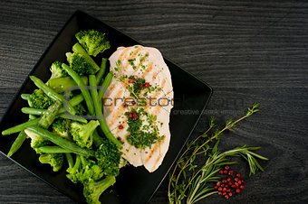 Delicious portion of chicken breast with steamed vegetables