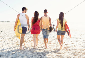 Friends walking at the beach