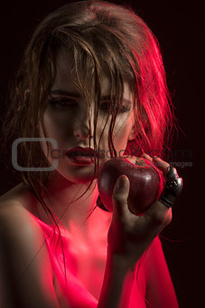 sexy girl in half-light with apple  
