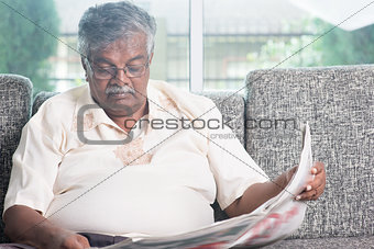 Old people reading newspaper