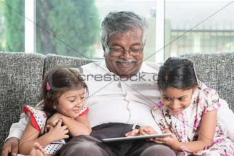 Grandfather and granddaughter using modern technology