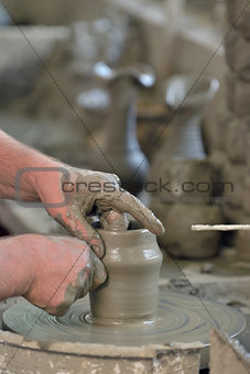Potter's hands making a pot