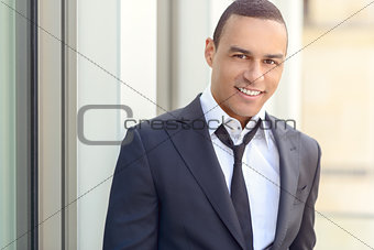 Attractive smiling businessman with a loosened tie