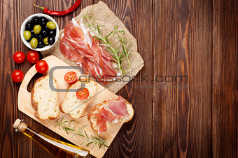 Bruschetta ingredients - prosciutto, olives, tomatoes