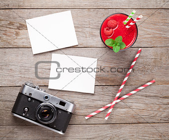 Vintage camera, two photos and raspberry smoothie