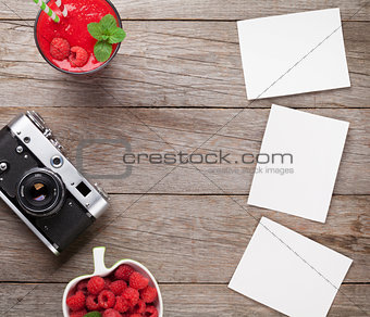 Vintage camera, photos and raspberry smoothie