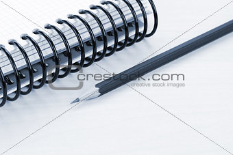 Office table with blank notepad and pencil
